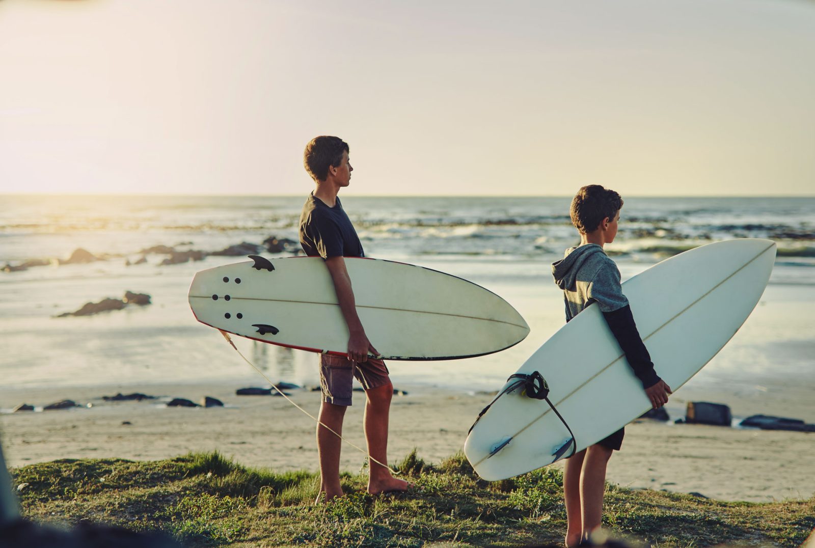 kids on beach with surfboards